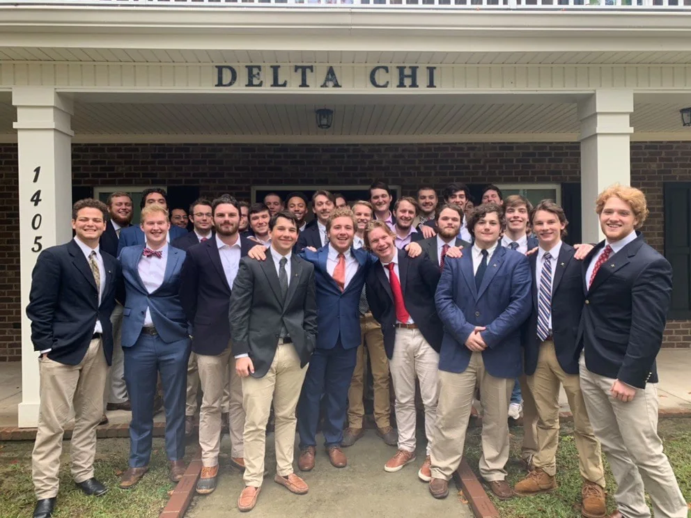 Delta Chi brothers standing in front of the Georgia Southern chapter house